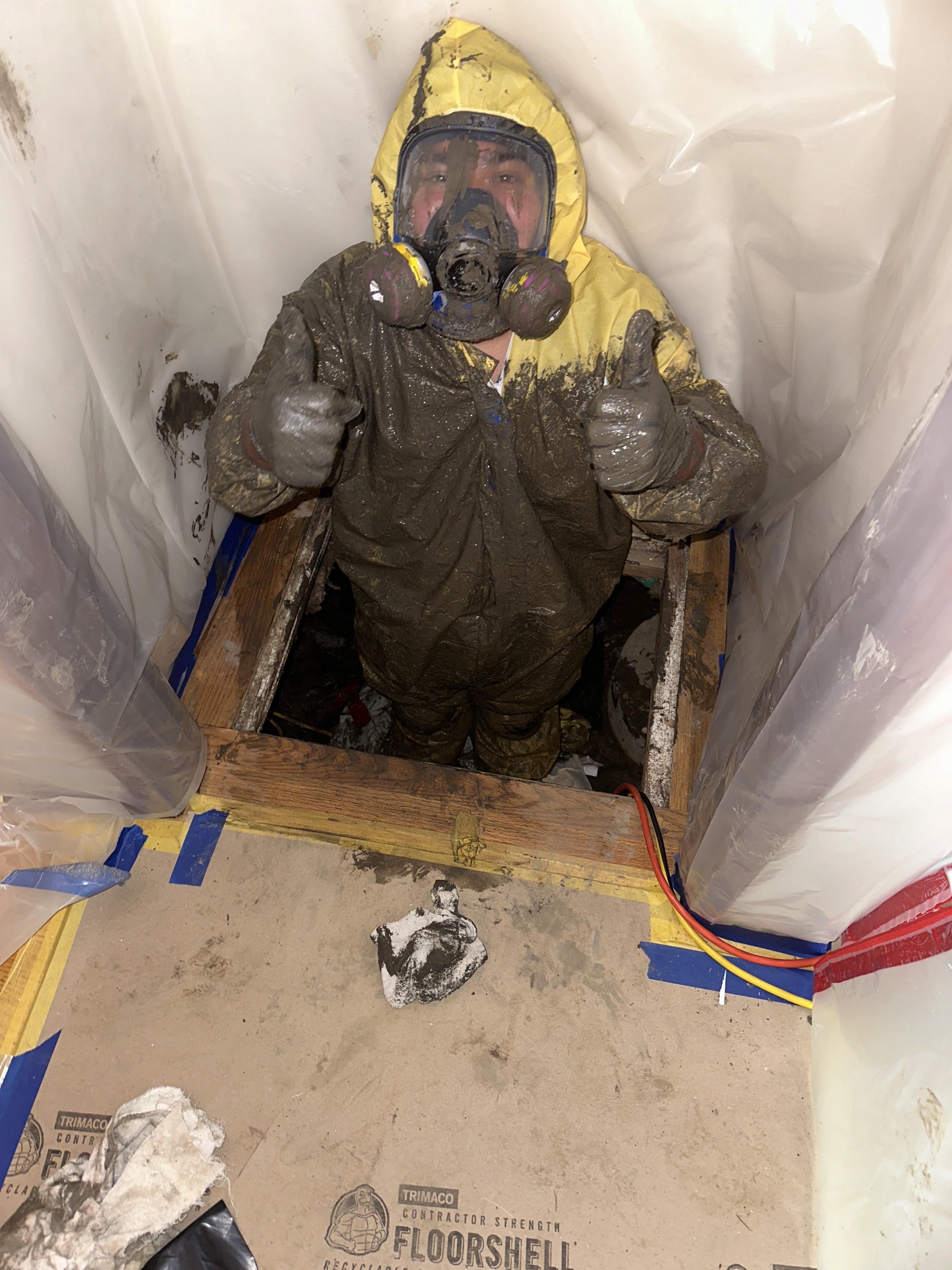Technician in full PPE for sewage cleanup